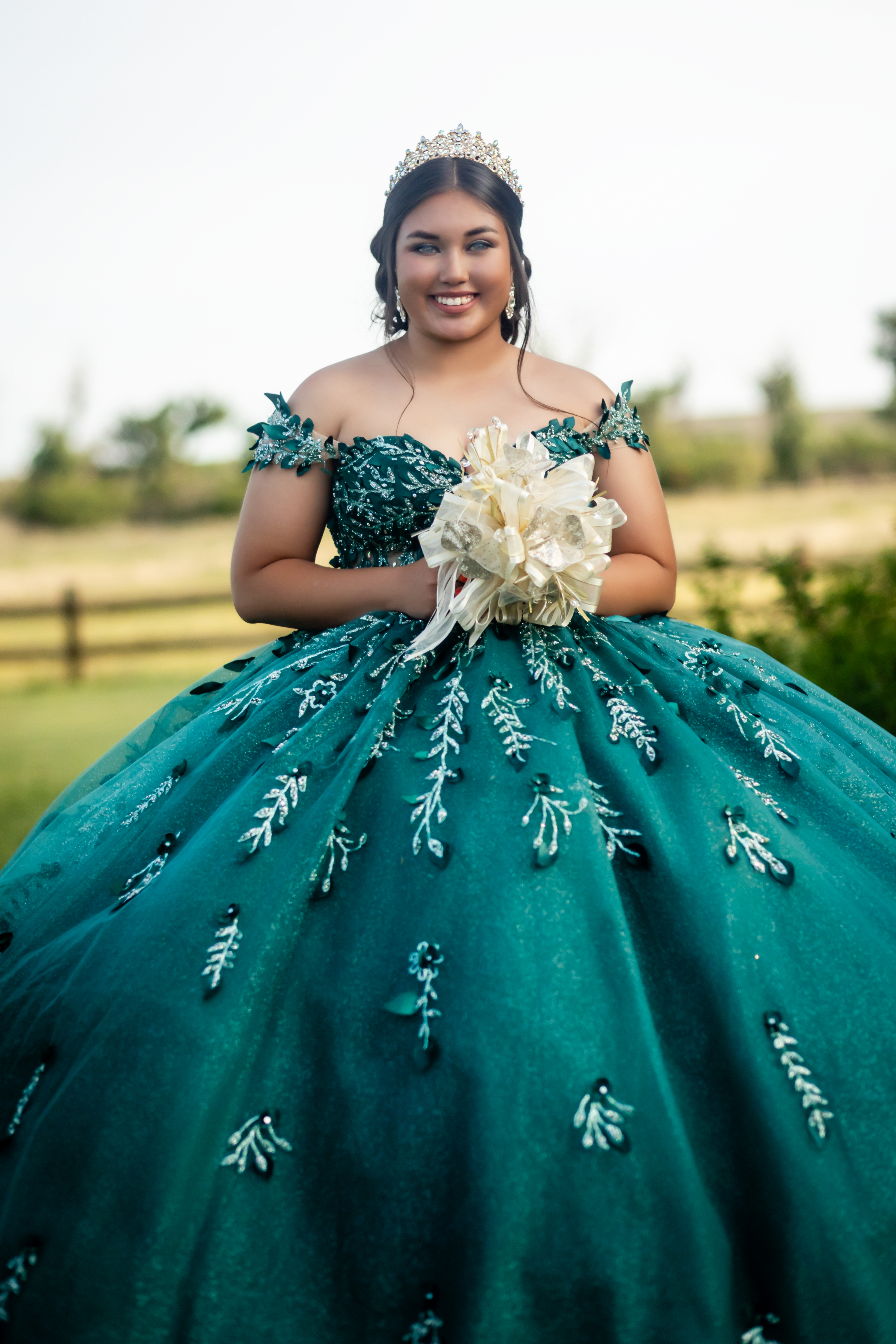 young lady holding her bouquet of flowers wearing a beautiful birthday dress